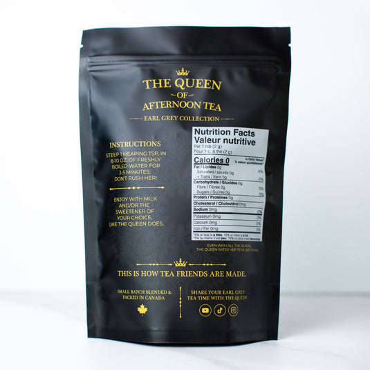 Translation missing: en.A black resealable stand-up pouch of 'The Queen of Afternoon Tea' from the Earl Grey Collection, shown against a plain white background. The back of the pouch features gold text and illustrations, including instructions, a nutrition facts label, and a small maple leaf logo