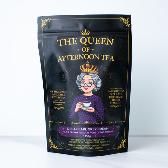 Translation missing: en.A black stand-up pouch of 'The Queen of Afternoon Tea' Decaf Earl Grey Cream tea, featuring a gold-embossed illustration of a crowned woman holding a teacup on a white background