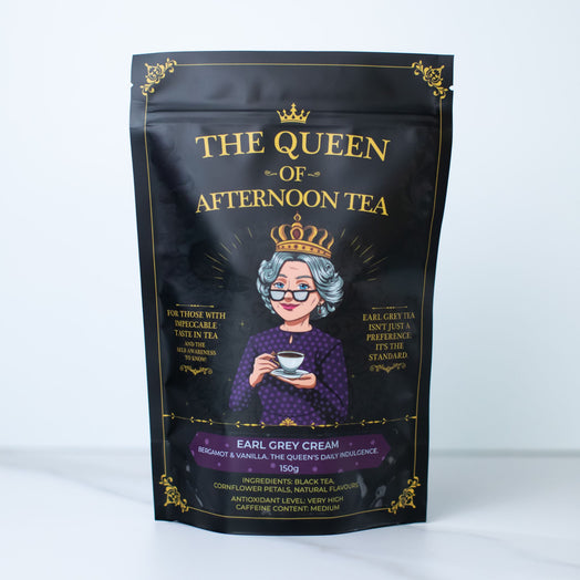 A black stand-up pouch of 'The Queen of Afternoon Tea' Earl Grey Cream tea, featuring a gold crown and gold lettering with an illustration of an elderly queen in a purple dress and crown.