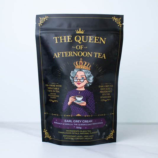 Translation missing: en.A black stand-up pouch of 'The Queen of Afternoon Tea' Earl Grey Cream tea, featuring a gold crown and gold lettering with an illustration of an elderly queen in a purple dress and crown