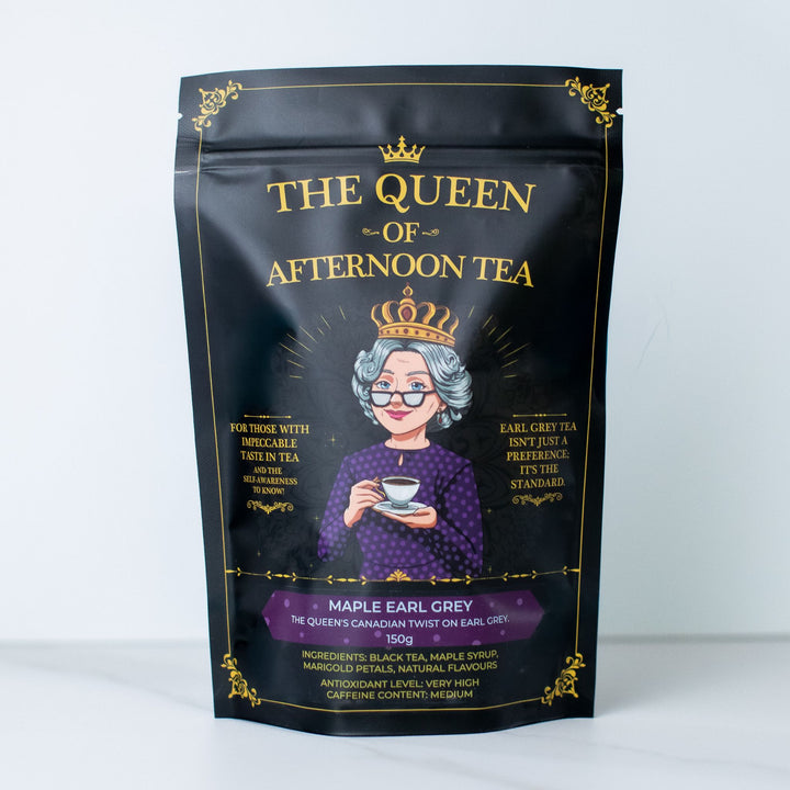 Translation missing: en.A black stand-up pouch of 'The Queen of Afternoon Tea' in Maple Earl Grey flavor, featuring a gold-embossed crown and ornate gold borders on a white background